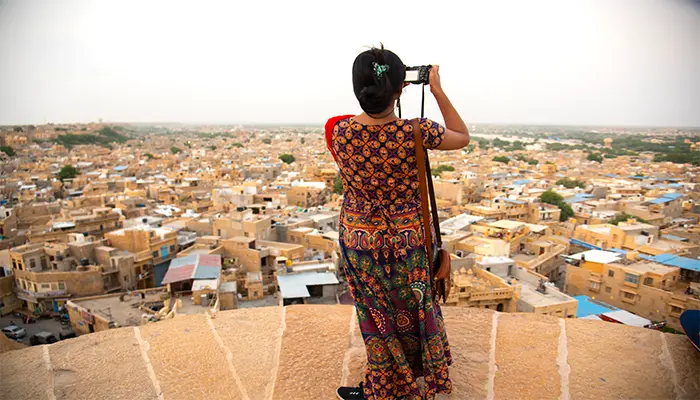 a woman taking a picture of a city