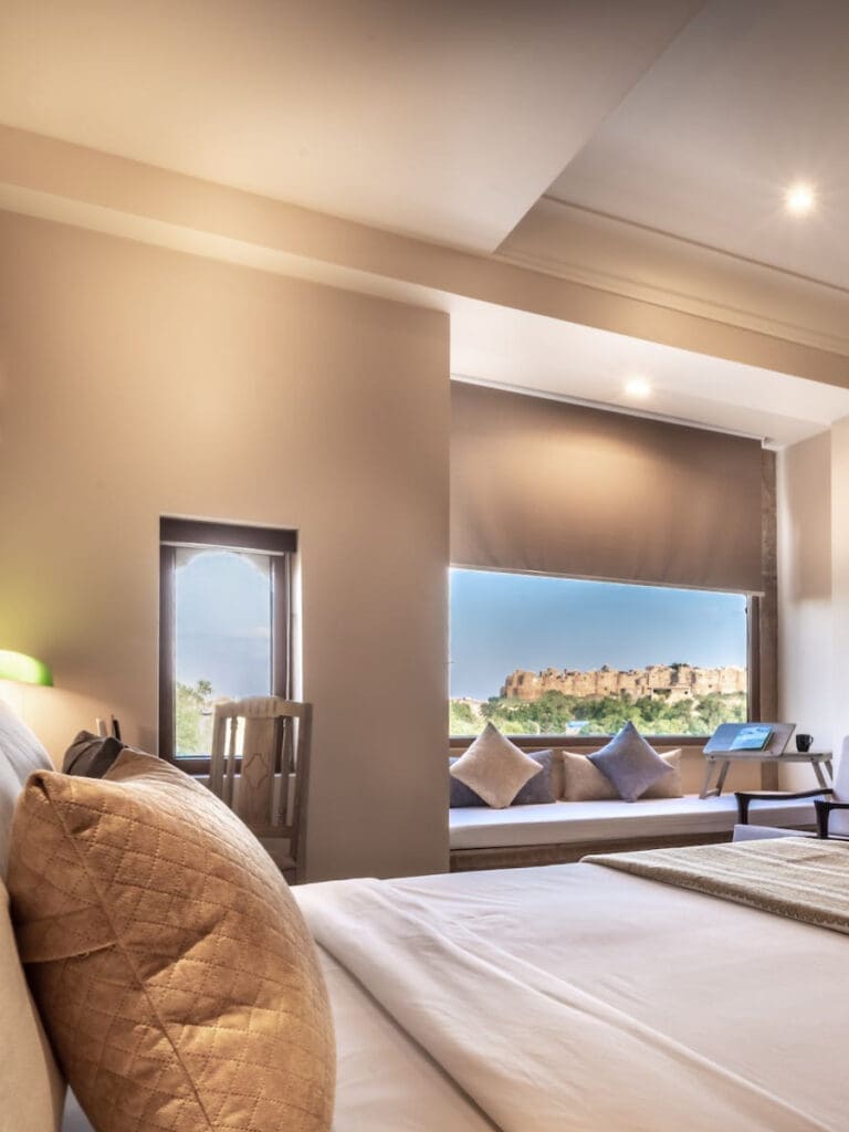 a bedroom with a window and a bed