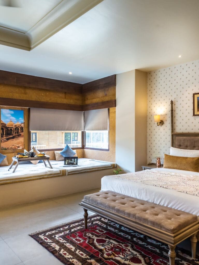 a bedroom with a bed and a window seat